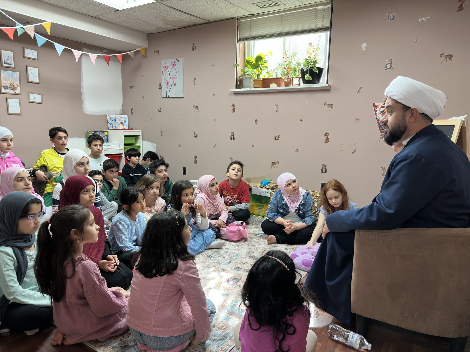 A teacher leading a lesson for seated children